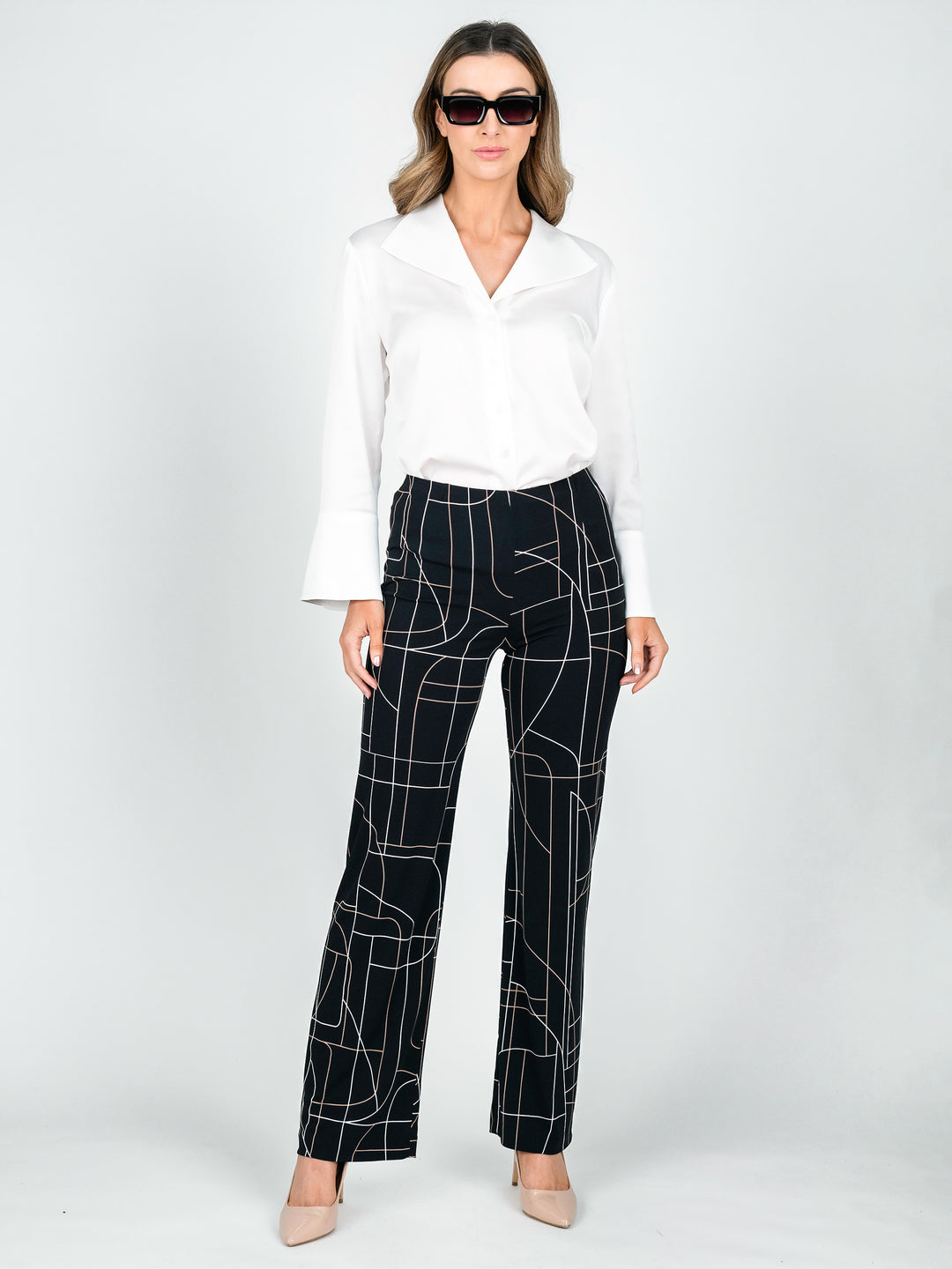 Women's stretchy jersey wide leg work pants with tan and white lines printed on black tucked in