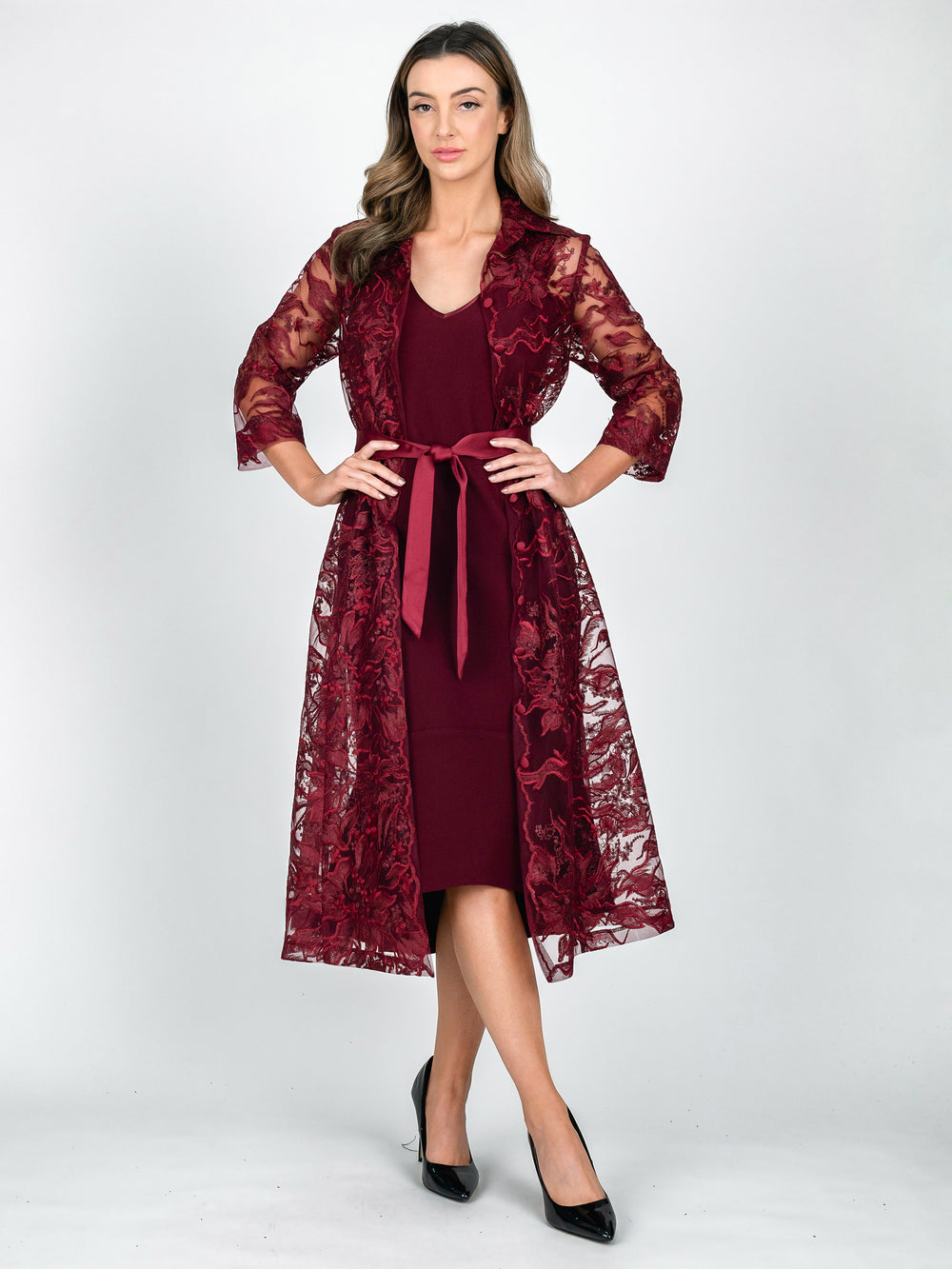 Lisa Barron burgundy red A-line lace coat dress with 3/4 length sleeves in a leaf and botanical embroidery worn over plain v-neck dress